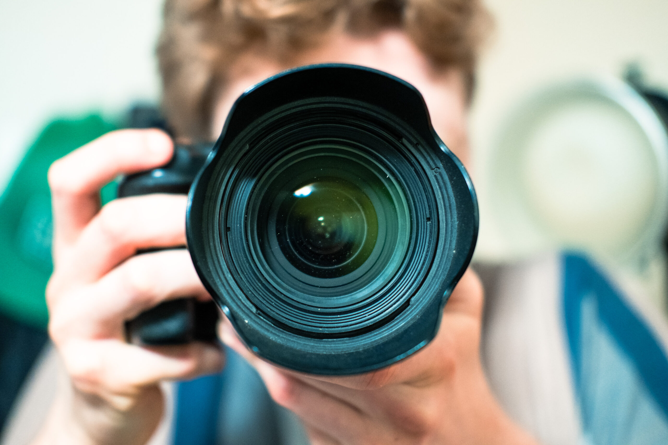 Cameraman holding video camera. The camera is being used to capture video for small businesses.